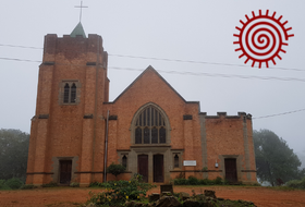 Livingstonia mission church in mist. Image by the author.